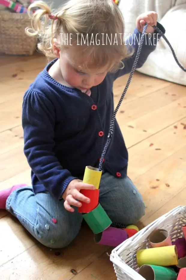 Toddler-threading-activity-with-giant-cardboard-beads-666x1000